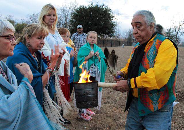 Eddie Sandoval burns sage during the burial of the remains of a centuries-old Native American woman at Oakwood Cemetery in Fort Worth on Dec. 21, 2017.